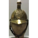 A BRASS FIREMANS HELMET WITH CHINSTRAP With photo of owner, Circa 1890 - 1940. Condition: very good