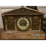 AN ONYX AND GILT METAL MOUNTED MANTEL CLOCK The rouge marble Egyptian Revival clock with gilt