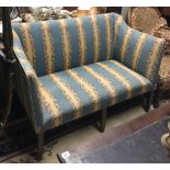 A MID 18TH CENTURY TWO SEAT SETTEE In fabric upholstery, raised on six square tapering legs. (