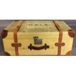 A VINTAGE CANVAS AND LEATHER BOUND RECTANGULAR TRAVEL TRUNK With brown leather corner protectors and