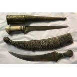 A 19TH CENTURY PERSIAN WHITE METAL DAGGER IN REPOUSSE SHEATH AND ANOTHER