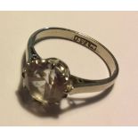 A VINTAGE 18CT WHITE GOLD AND WHITE SAPPHIRE RING The single round cut stone held in a plain gold