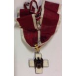 A GERMAN SOCIAL WELFARE MEDAL WITH RIBBON. Condition: small loss to enamel of one wing, very good