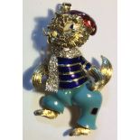 MOBA, AN 18CT DIAMOND AND ENAMEL FIGURAL BROOCH Cast as a cat wearing an enamelled jumper with