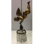 A 20TH CENTURY GILTWOOD HANGING LIGHT Modelled as a cherub holding a basket with suspended faceted