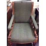 AN EDWARDIAN MAHOGANY ARMCHAIR Having green fabric covering and elongated scrolled arms set with