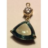 A VINTAGE YELLOW METAL, DIAMOND AND AQUAMARINE PENDANT Having a single round cut diamond and prism