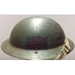 A BRITISH HELMET With the combined operations insignia painted to side, liner date 1939.