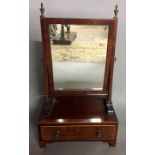 A GEORGIAN MAHOGANY AND BOXWOOD BANDED TOILET MIRROR With brass finials and trinket drawer. (33cm