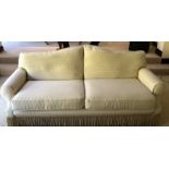 A VICTORIAN DESIGN THREE SEAT SETTEE In cream and gold fabric upholstery.