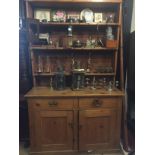 A LATE VICTORIAN PINE DRESSER With open shelves above two drawers and cupboards. (120cm x 195cm x