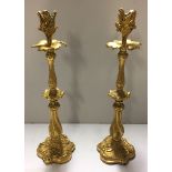 A PAIR OF LATE 19TH CENTURY FRENCH GILT BRONZE CANDLESTICKS The shaped columns with foliate and