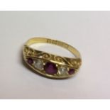 A VINTAGE 18CT GOLD, RUBY AND DIAMOND FIVE STONE RING Having three graduating rubies interspersed