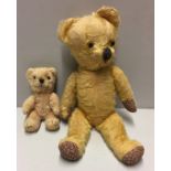 A VINTAGE MOHAIR TEDDY BEAR Having glass eyes and foliate upholstered paws, sold together with a