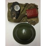 A BRITISH WORLD WAR II GAS MASK. Condition: helmet repainted
