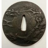A HOLLOW FORM TSUBA Decorated with trees and animals, with feint signature.