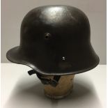 A WORLD WAR I AUSTRIAN M17 HELMET Liner and chinstrap present, nice patina.