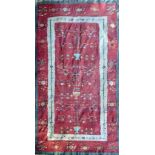 AN ANTIQUE PERSIAN KELIM With Tree of Life designs, on a faded madder field. (275cm x 187cm)