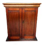 A MAHOGANY TABLE TOP CABINET With two panelled doors enclosing a shelved interior, complete with