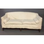 A GEORGE III PERIOD THREE SEAT SETTEE With loose cushion and cream loose cushion, raised on six