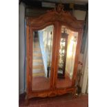 A 19TH CENTURY FRENCH WALNUT TWO MIRRORED DOOR ARMOIRE Raised on cabriole legs.