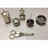 A SELECTION OF EARLY 20TH CENTURY SILVER CONDIMENTS To include a mustard pot with acorn finial