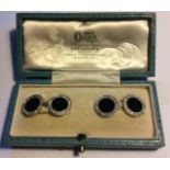 A VINTAGE PAIR OF YELLOW METAL, DIAMOND AND ONYX CUFFLINKS Having a single row of round cut diamonds