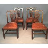 A SET OF FOUR MAHOGANY CHAIRS Having pierced vase splat backs over drop in burgundy leather seats,