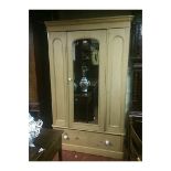 A VICTORIAN PINE WARDROBE With a single mirrored door above a drawer. (124cm x 195cm x 63cm)