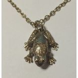 A 9CT GOLD FROG PENDANT Complete with a fine 9ct gold chain.