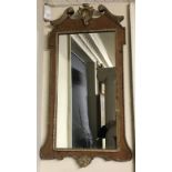 A 19TH CENTURY BURR WALNUT AND GILT FRAMED MIRROR The swan necked pediment centred with a shell