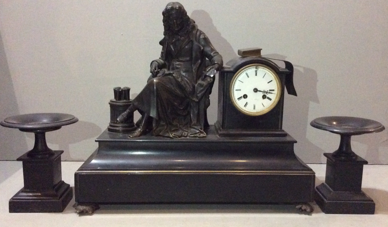 A 19TH CENTURY FRENCH BLACK MARBLE THREE PIECE CLOCK GARNITURE Mounted with a bronze statue of a