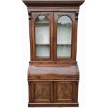 A VICTORIAN MAHOGANY CYLINDER BUREAU BOOKCASE With deep cushion cornice above two arched glazed