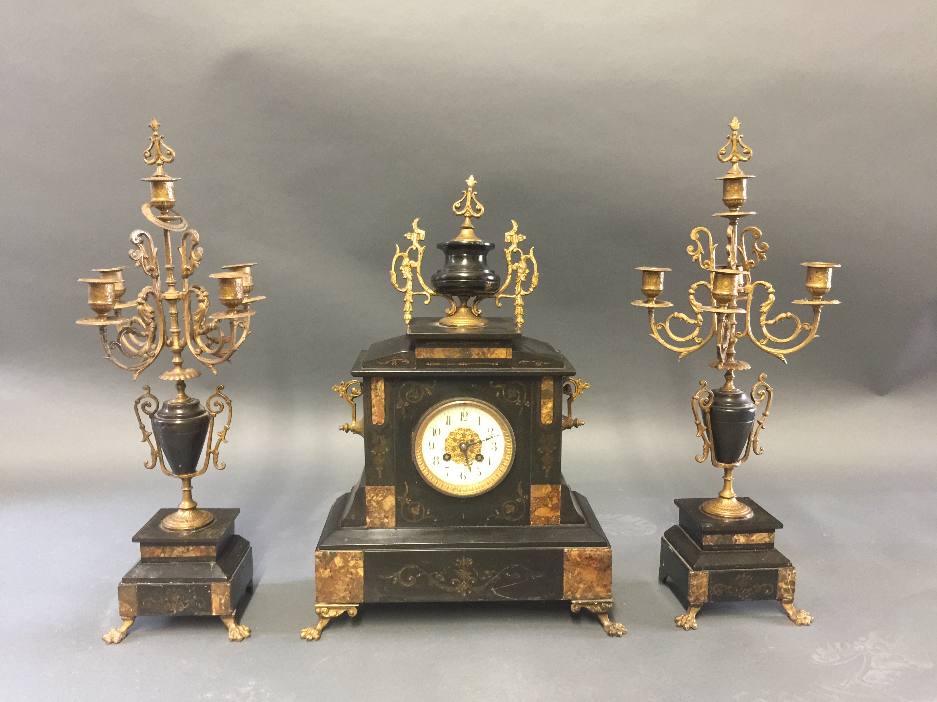 LEVI FRERES, A LATE 19TH CENTURY THREE PIECE BLACK MARBLE CLOCK GARNITURE WITH CANDELABRA.