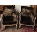 A PAIR OF REGENCY DESIGN LIBRARY ARMCHAIRS With crush green upholstery and silvered painted frame,