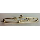 A VINTAGE 9CT GOLD AND DIAMOND ART NOUVEAU STYLE BROOCH Having a stylized scroll and set with a