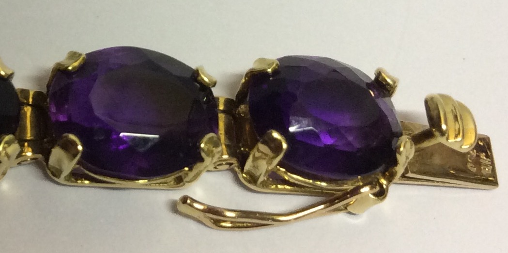 AN 18CT GOLD AND AMETHYST BRACELET Having a single row of oval cut amethysts set in articulated - Image 2 of 3