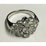 AN EARLY 20TH CENTURY 18CT WHITE GOLD AND DIAMOND CLUSTER RING Unmarked (size L).