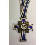 A WORLD WAR II GERMAN (BRONZE?) MOTHER'S CROSS With a length of ribbon. Condition: enamel very good,