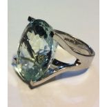 A VINTAGE 14CT WHITE GOLD AND AQUAMARINE RING Having a single oval cut stone held in an open