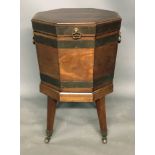 A GEORGIAN MAHOGANY HEXAGONAL WINE COOLER On a stand with four tapering square legs terminating on
