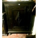 A 16TH/17TH CENTURY ITALIAN OAK AND OLIVE WOOD CUPBOARD The single door with central lozenge, on bun