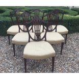 A SET OF SIX GEORGE III PERIOD MAHOGANY DINING CHAIRS With shield backs and overstuffed seats,