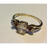 A 14CT GOLD AND DIAMOND THREE STONE RING Having an oval cut central stone flanked by two round cut