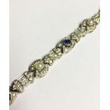 AN EDWARDIAN WHITE GOLD, DIAMOND, PEARL AND SAPPHIRE ENCRUSTED BRACELET. (20cm)