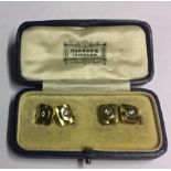 A PAIR OF 18CT GOLD AND SOLITAIRE DIAMOND SET CUFFLINKS.