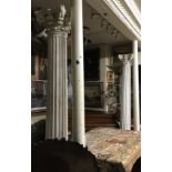 A PAIR OF WHITE PLASTER COLUMNS WITH CORINTHIAN CAPITALS AND FLUTED PILLARS. (239cm x 32cm)