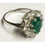 AN 18CT WHITE GOLD, EMERALD AND DIAMOND RING Set with a pear cut emerald surrounded by diamonds,