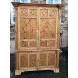 A 19TH CENTURY PINE HOUSE KEEPERS CUPBOARD With mounded cornice above four doors applied with