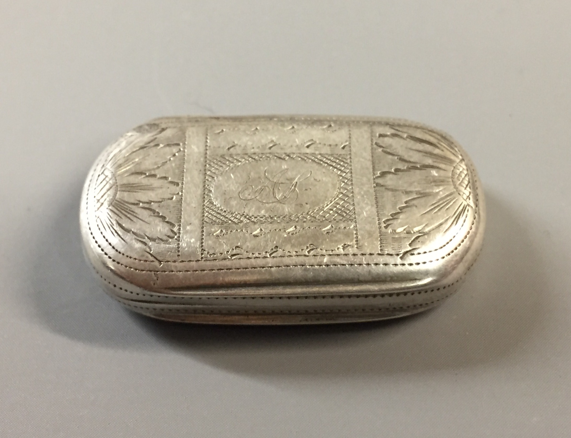 A GEORGE III SILVER RECTANGULAR VINAIGRETTE The lid with wriggle work, floral decoration and incised
